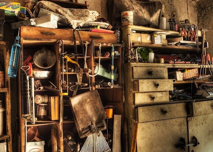picture of messy garage in home bought as is for cash near tacoma wa